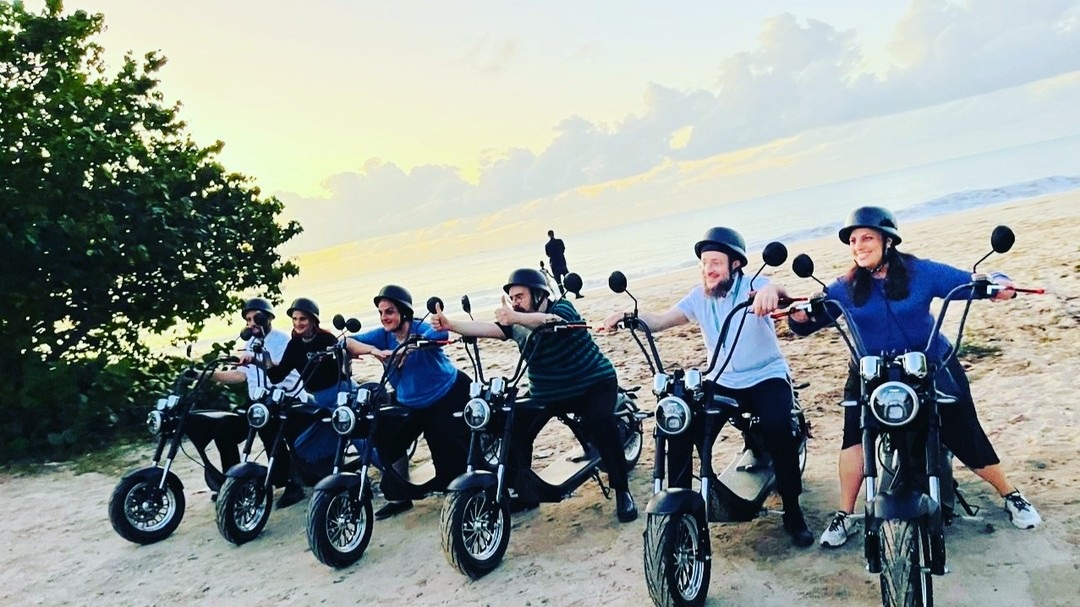 Happy tourists on electric bikes in Antigua